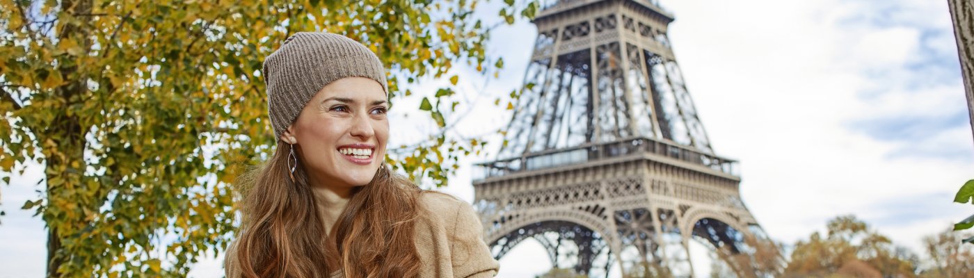 smiling elegant woman tourist having excursion in Paris, France