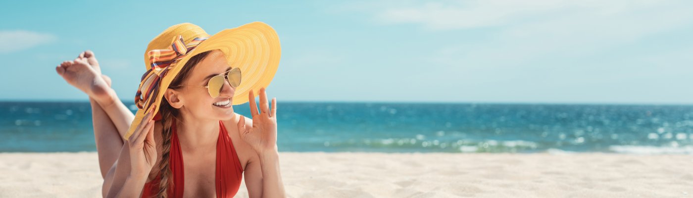 Badereisen ab Bamberg Woman enjoying her vacation by the sea tanning in the beach sand 4
